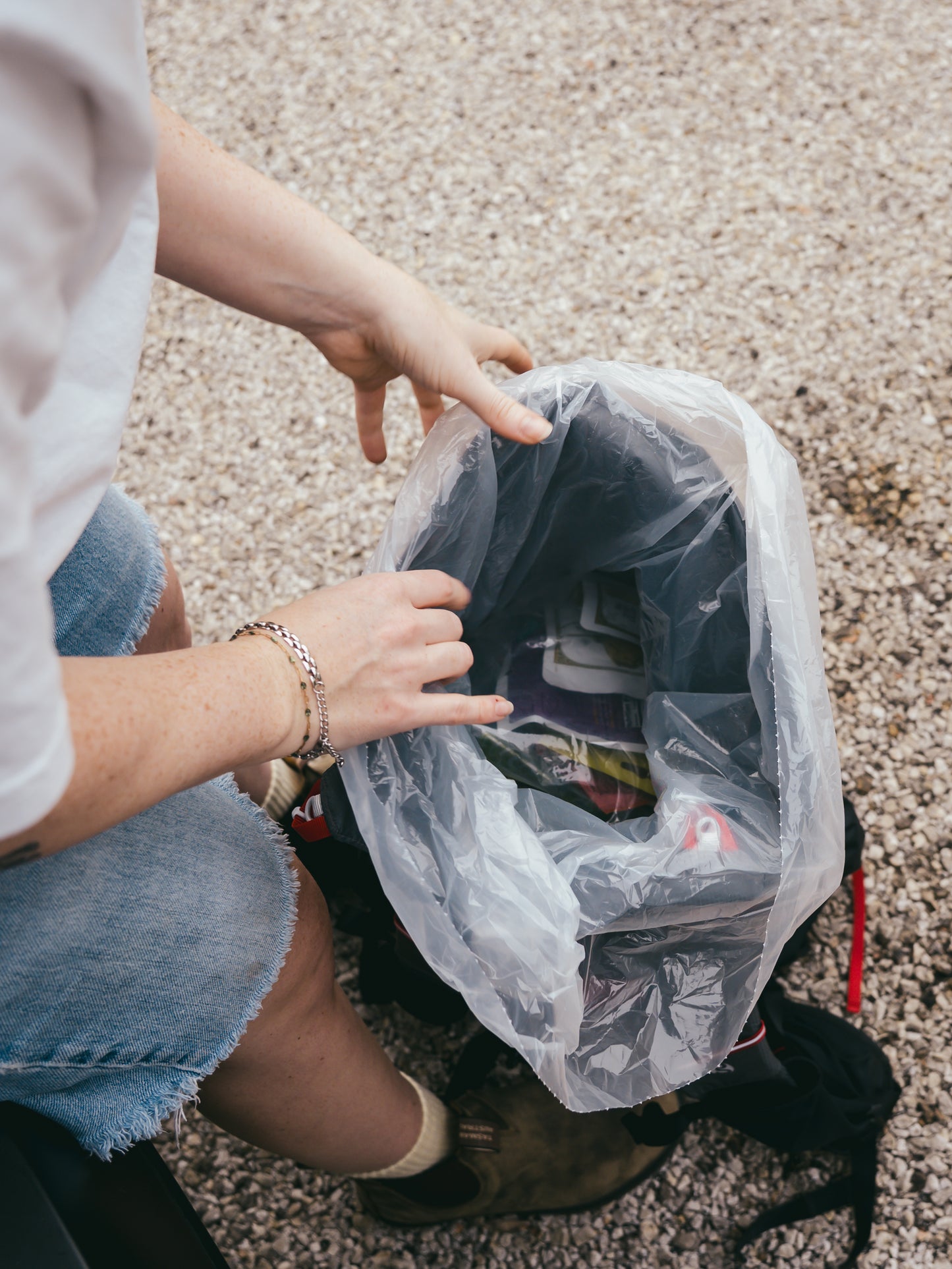 Person organizing a packliner in a backpack